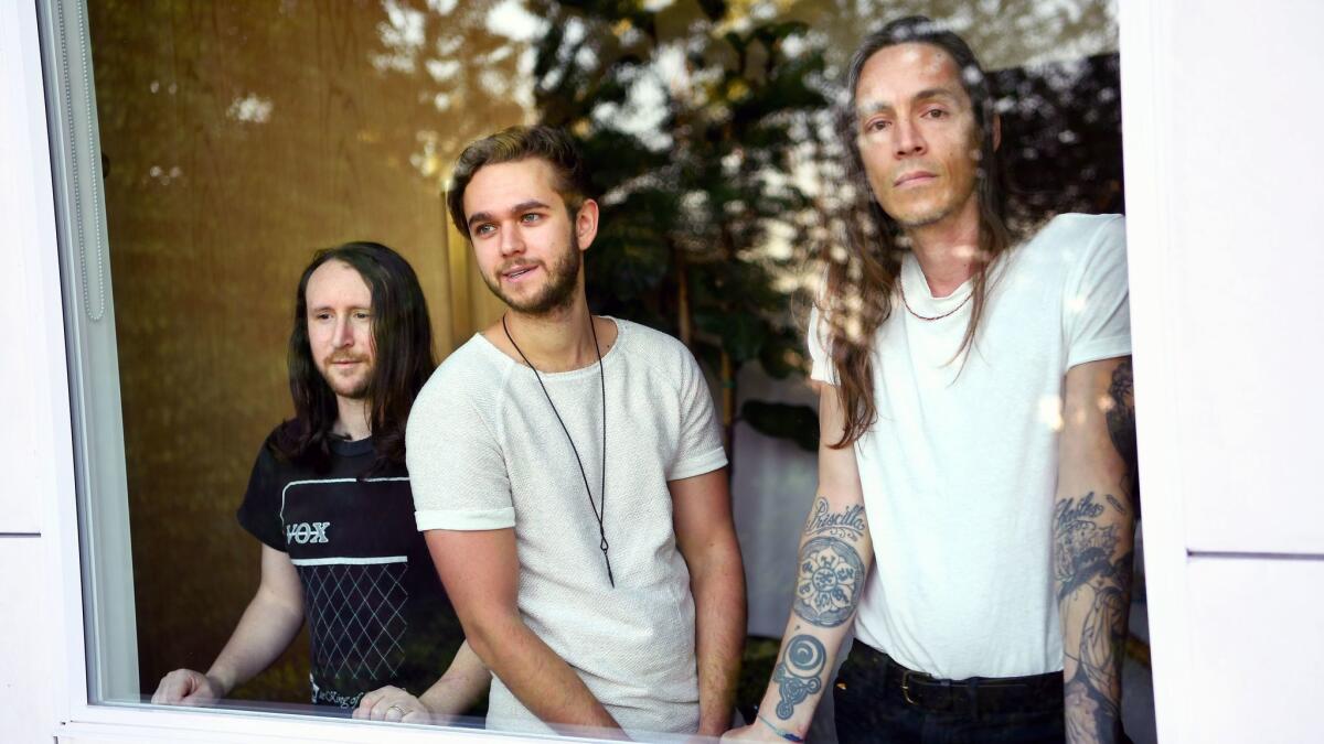 Incubus members Mike Einziger, left, and Brandon Boyd, right, with Zedd at Zedd's home in Los Angeles.