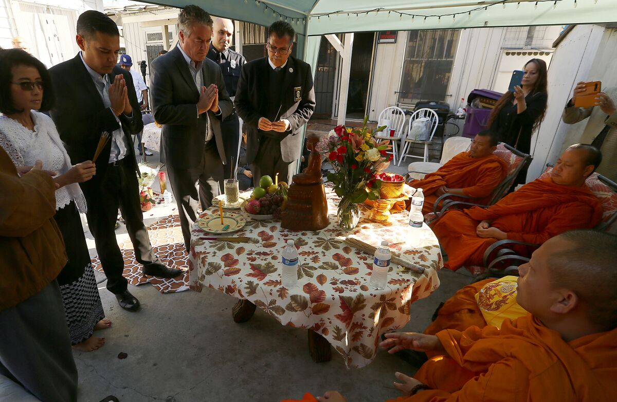 Long Beach Mayor Robert Garcia attends a Buddhist memorial ceremony