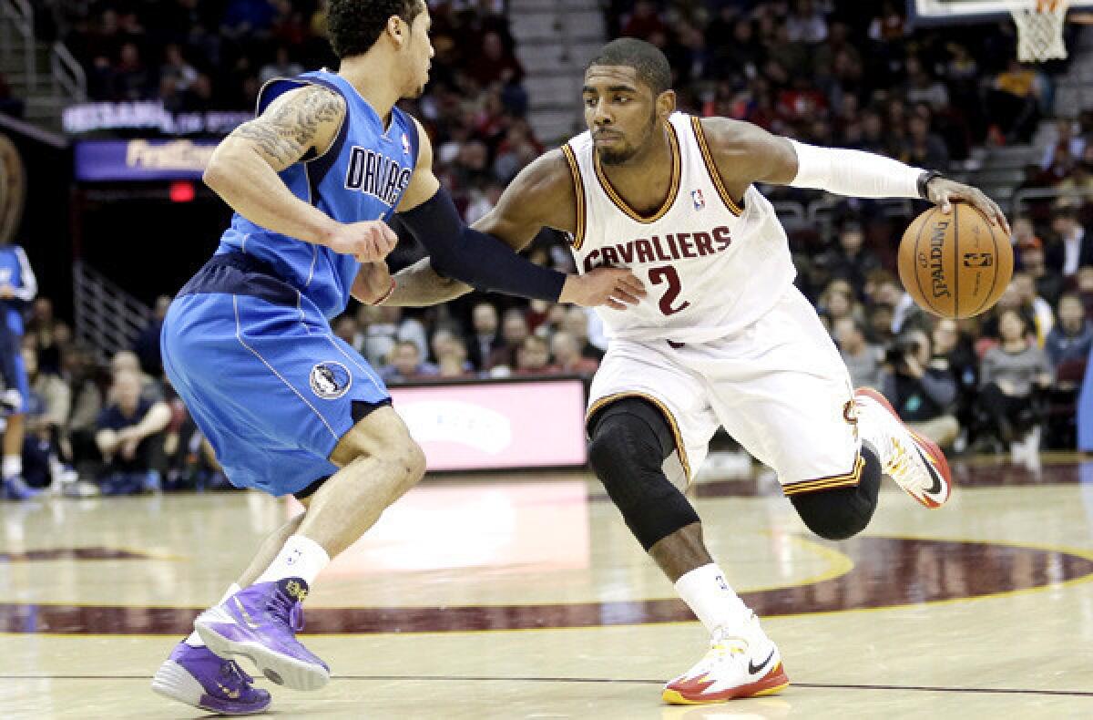 Cavaliers point guard Kyrie Irving drives against Mavericks point guard Shane Larkin during a game in Cleveland.