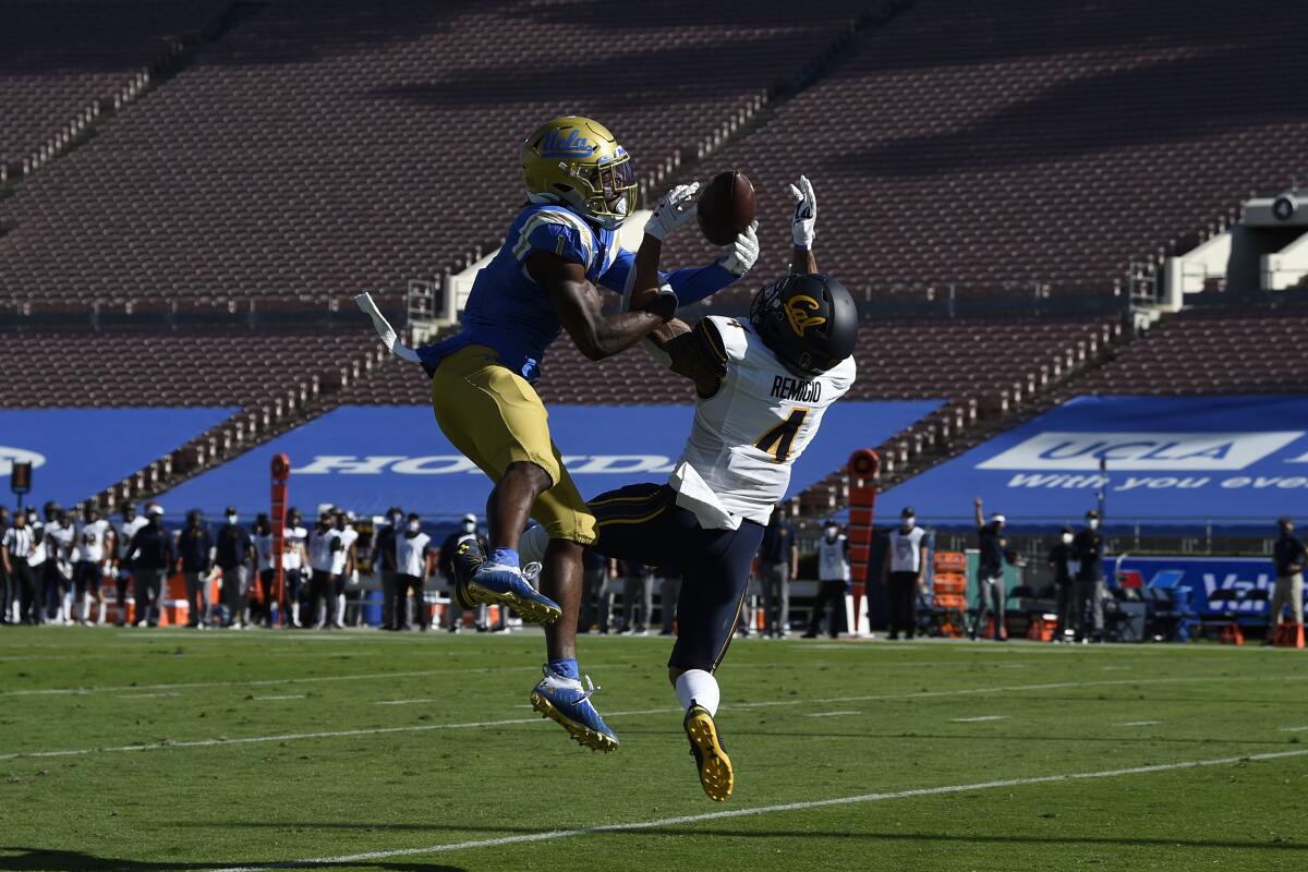 UCLA defensive back Jay Shaw, left, deflects a pass intended for California wide receiver Nikko Remigio.