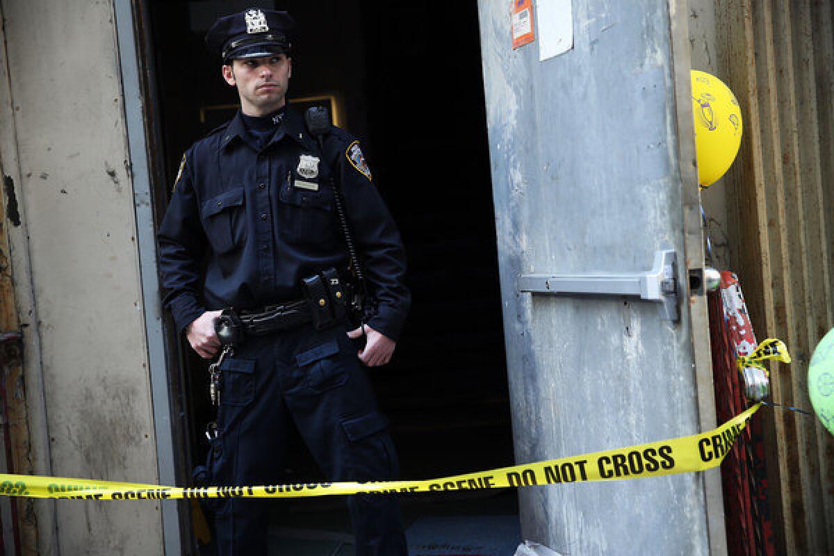 A police officer guards the site in Lower Manhattan where a piece of debris, believed to be from one of the planes destroyed on Sept. 11, 2001, was found wedged between two buildings.