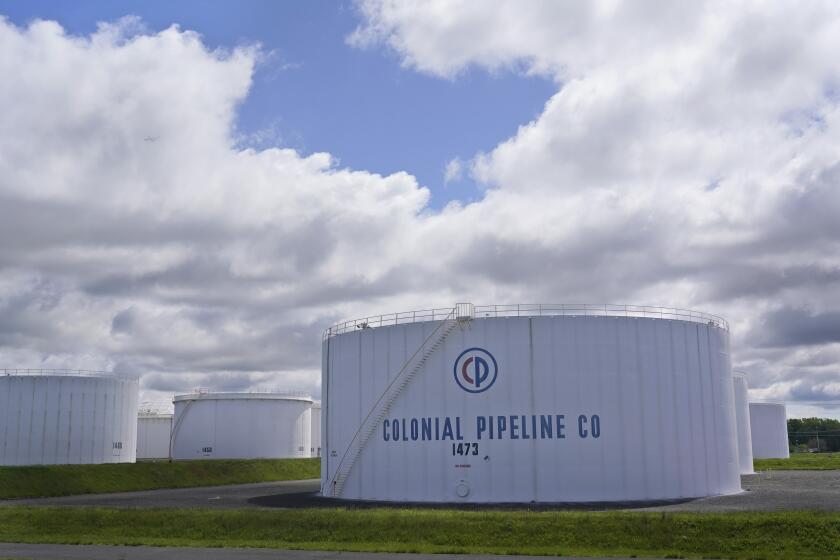 Colonial Pipeline storage tanks are seen in Woodbridge, N.J., Monday, May 10, 2021. Gasoline futures are ticking higher following a cyberextortion attempt on the Colonial Pipeline, a vital U.S. pipeline that carries fuel from the Gulf Coast to the Northeast. (AP Photo/Seth Wenig)