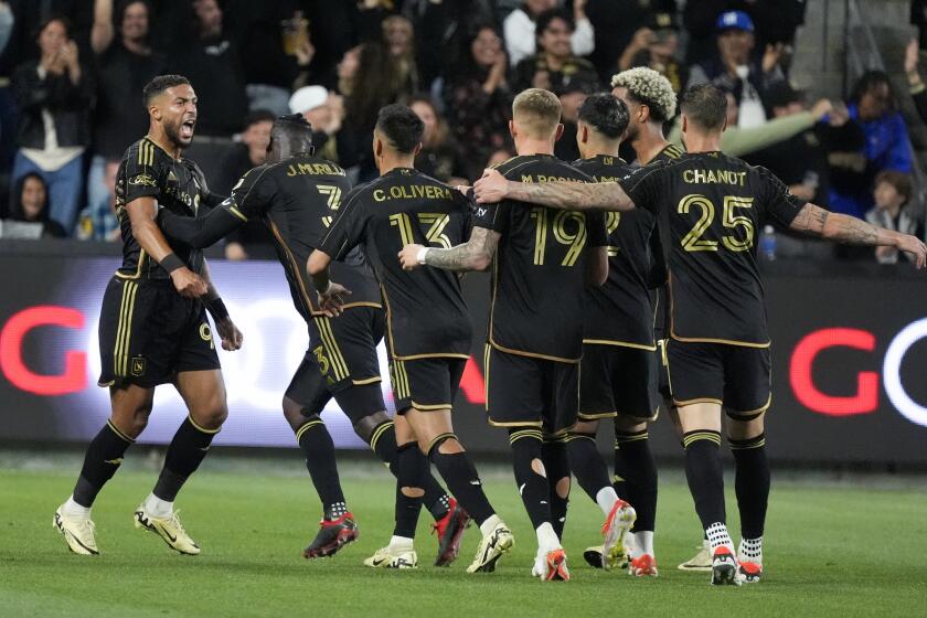 Los Angeles FC forward Denis Bouanga, left, celebrates his goal against the Portland Timbers with teammates during the second half of an MLS soccer match Saturday, April 27, 2024, in Los Angeles. (AP Photo/Marcio Jose Sanchez)