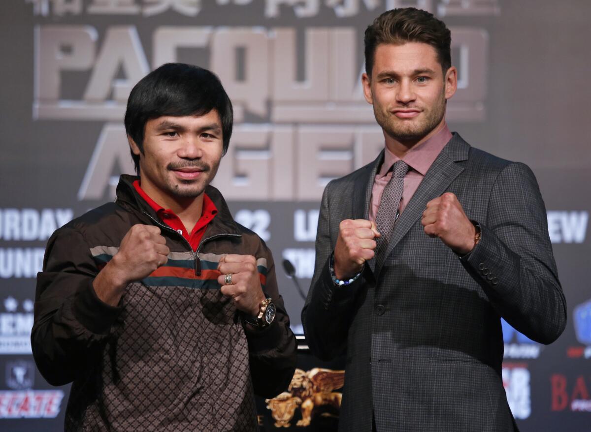 World Boxing Organization welterweight champion Manny Pacquiao, left, and WBO junior-welterweight champion Chris Algieri pose during a news conference in Macao, China.