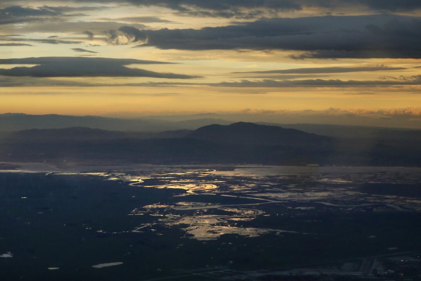 Mt. Diablo is silhouetted above the Sacramento River delta as seen from a NOAA research aircraft flying into an incoming atmospheric river storm.