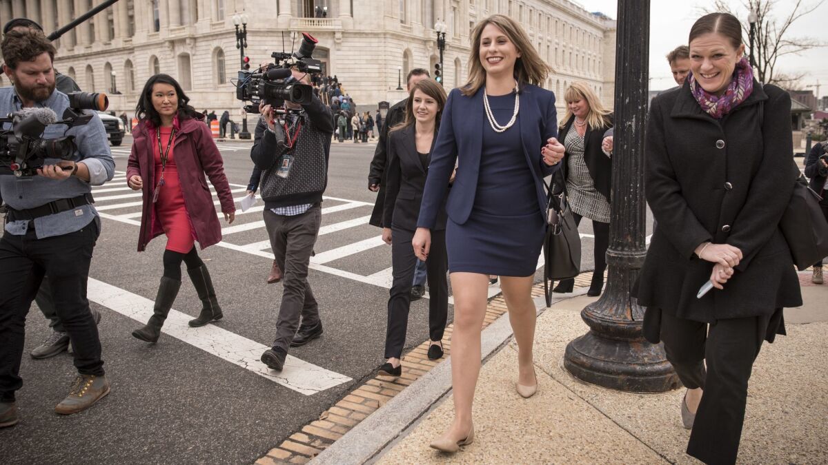 Rep. Katie Hill (D-Agua Dulce), flanked by family and media, crosses the street to the U.S. Capitol on Thursday, the first day of the new Congress.
