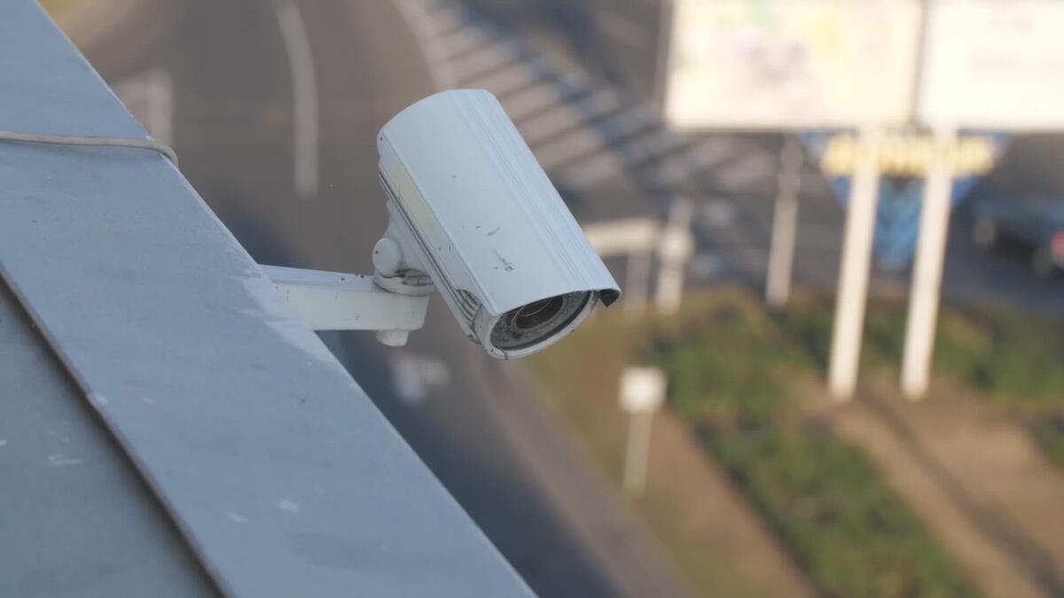 A surveillance camera on the side of a building.