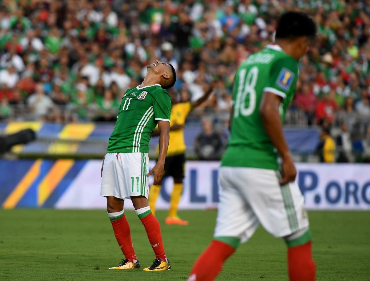 Mexico's Elias Hernandez (L) reacts after missing a shot on goal before they were defeated 1-0 by Jamaica in their semi-final game during the 2017 CONCACAF Gold Cup at the Rose Bowl Stadium in Pasadena, California on July 23, 2017.