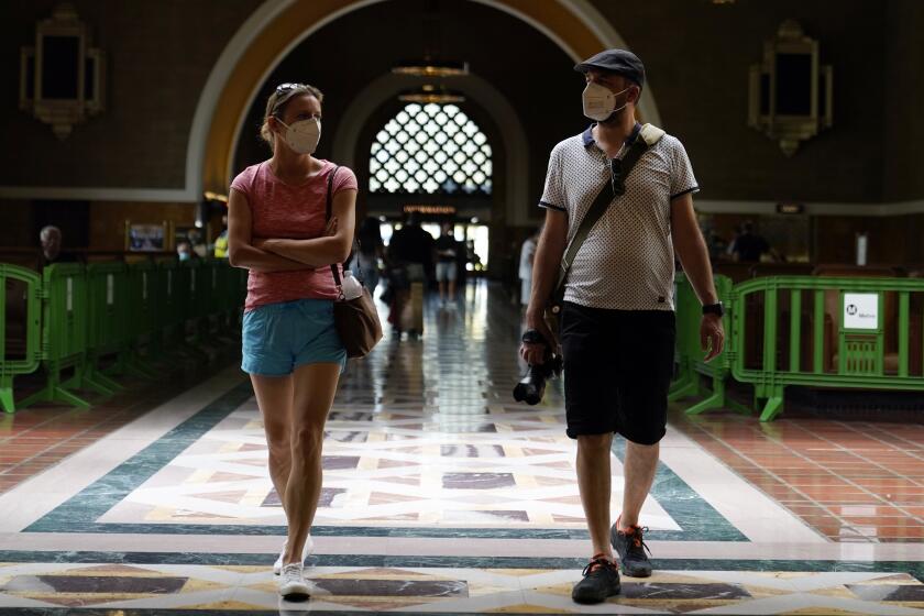 Visitors wears masks inside Union Station Thursday, July 28, 2022, in Los Angeles.  