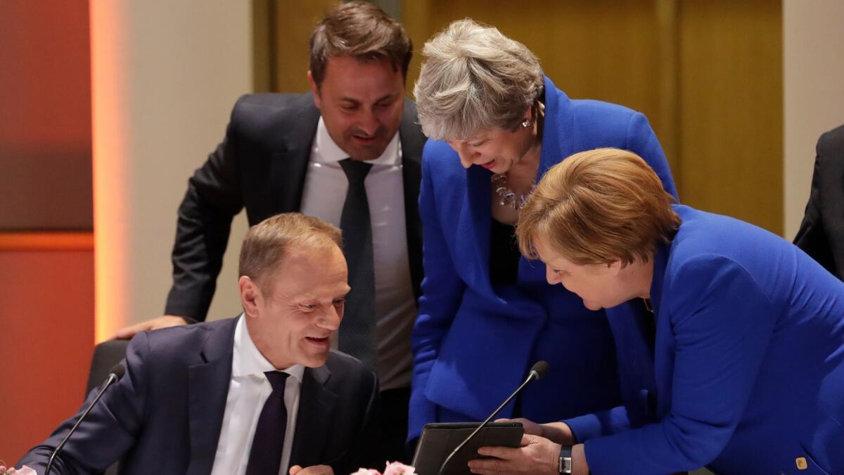 European Council President Donald Tusk, left, Luxembourg Prime Minister Xavier Bettel, British Prime Minister Theresa May and German Chancellor Angela Merkel at the start of a special European Union summit on Brexit in Brussels on April 10, 2019.