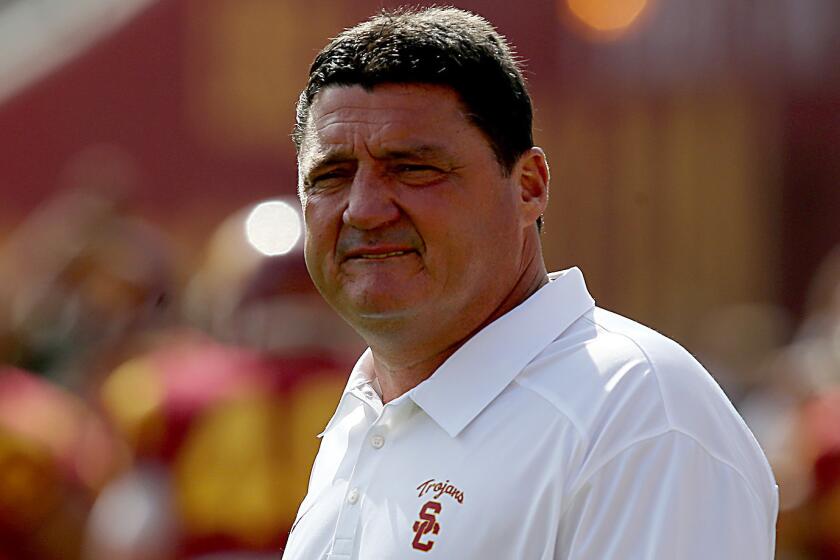 USC interim head coach Ed Orgeron watches his players warm up before a game against Utah in October 2013. Orgeron has been hired as Louisiana State's defensive line coach.