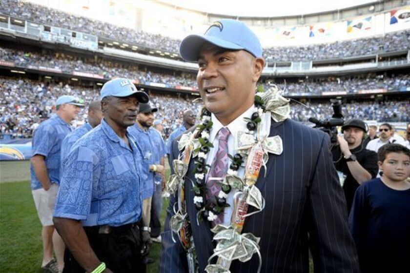 FILE -In this Nov. 27, 2011, file photo, former San Diego Chargers great Junior Seau smiles during his induction into the Chargers Hall of Fame during a halftime ceremony of an NFL football game in San Diego. Police say Seau, a former NFL star, was found dead at his home in Oceanside, Calif., Wednesday, May 2, 2012, after responding to a shooting there. He was 43. (AP Photo/Denis Poroy, File)
