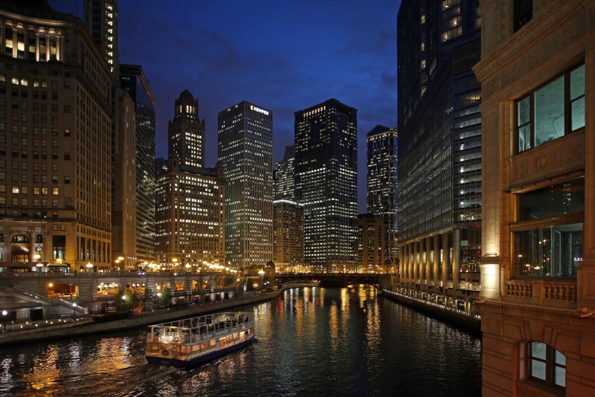 A tour boat makes its way down the Chicago River against the skyline on Friday, Nov. 15, 2013.