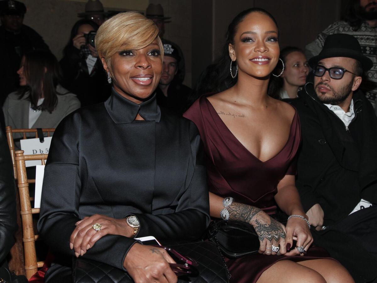Mary J. Blige, left, and Rihanna beam as they attend the Zac Posen Fall 2015 show.
