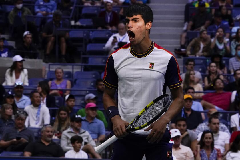 Carlos Alcaraz, of Spain, reacts after winning a point against Stefanos Tsitsipas.