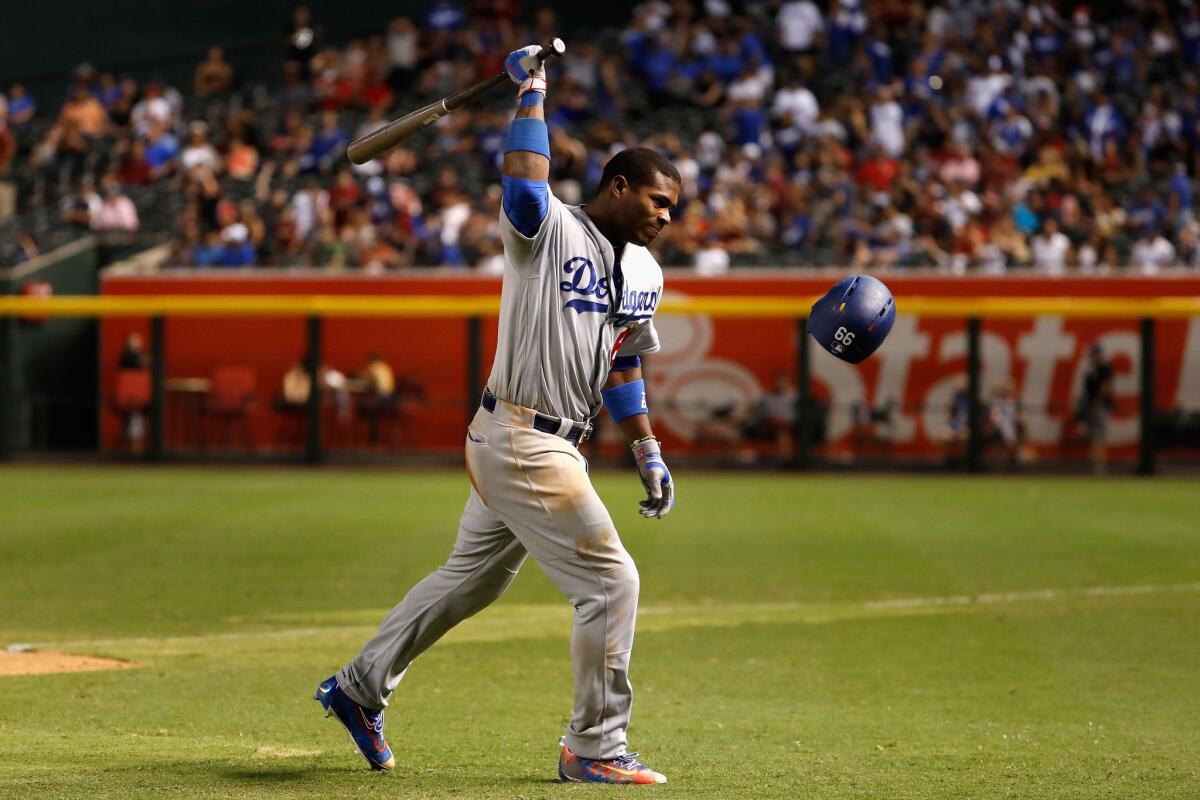 Dodgers outfielder Yasiel Puig, swinging at his helmet after grounding out, is being sent to the minors.