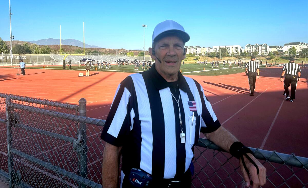 Brian Brennan poses for a photo before a high school football game.