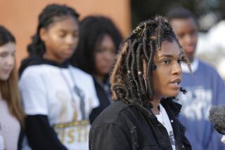 Helix High senior Brianna Bell, right, surrounded by fellow students, spoke at a news conference about an incident in which a La Mesa Police officer was seen on video throwing her to the ground after she refused to leave the school. (Photo by K.C. Alfred/ San Diego Union -Tribune)