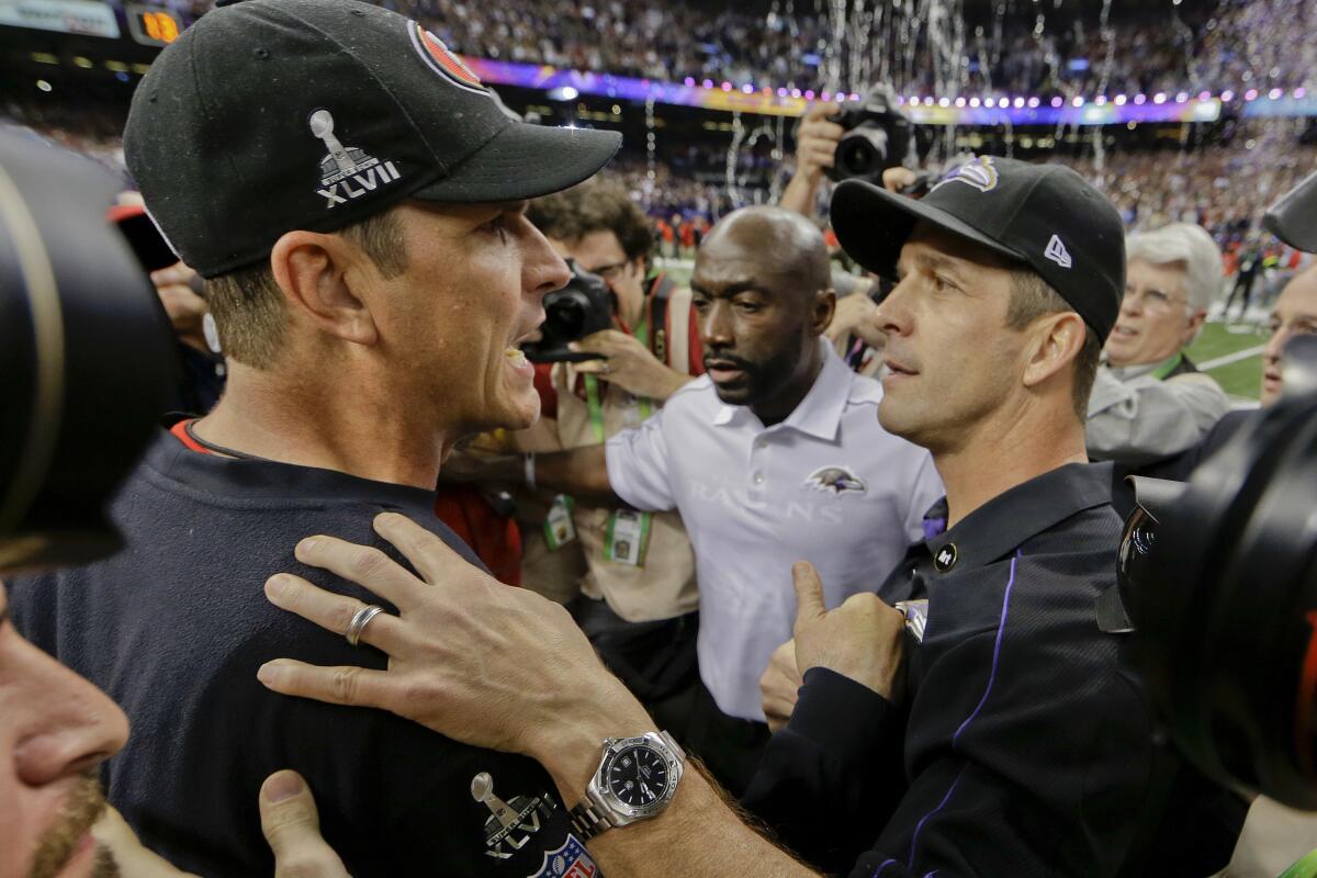 Ravens coach John Harbaugh (right) and 49ers coach Jim Harbaugh meet on the field after Super Bowl XLVII.