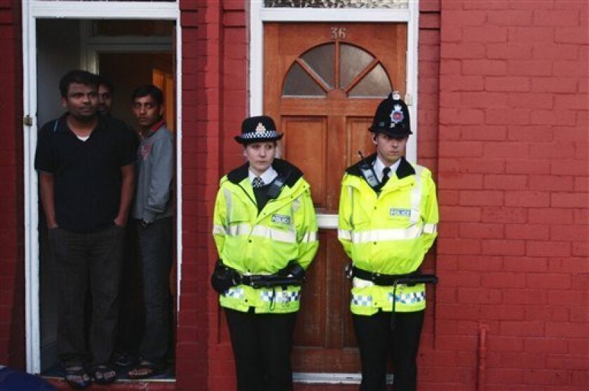 British police officers stand guard outside a residence in Manchester, after anti-terrorist raids across northwest England, Wednesday April 8, 2008. British police arrested 10 men Wednesday in raids across a wide area including the cities of Manchester and Liverpool. (AP Photo/Martin Rickett, PA)