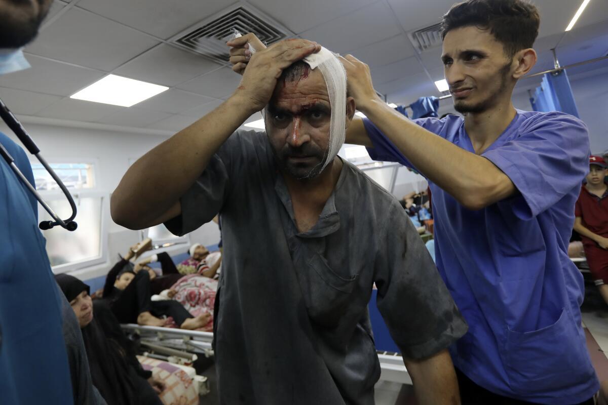 An injured Palestinian man receives treatment at Shifa Hospital in Gaza City. 
