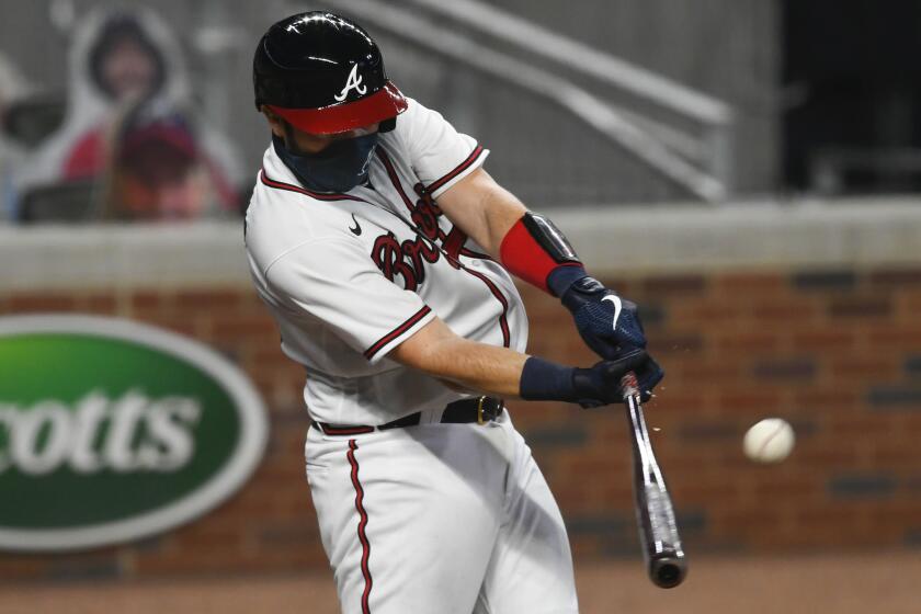 Atlanta Braves' Travis d'Arnaud hits a line-drive double during the sixth inning of the team's baseball game against the Tampa Bay Rays, Wednesday, July 29, 2020 in Atlanta. The Braves won 7-4. (AP Photo/John Amis)