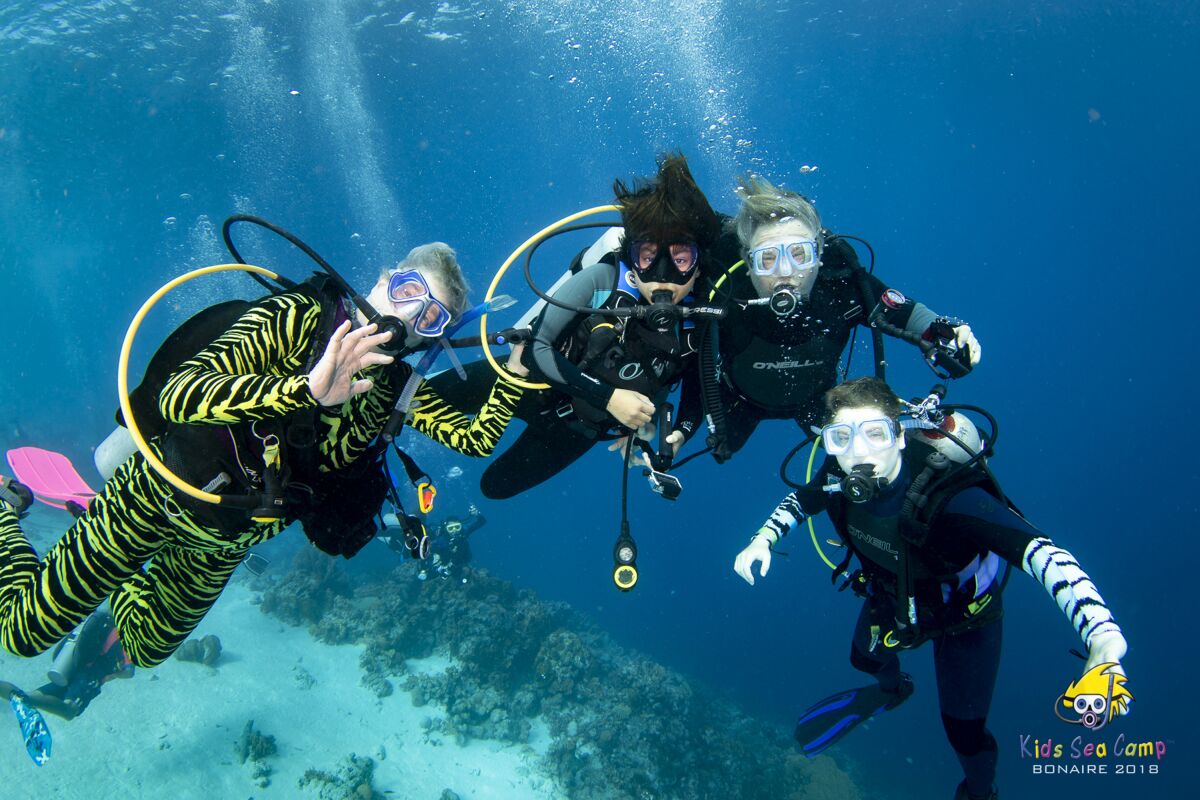 From left, Diana Adamic, Berenice Felipa, Steve Salika and Tia Salika-Adamic enjoying a dive during a 2018 Thanksgiving vacation trip off the coast of Venezuela.