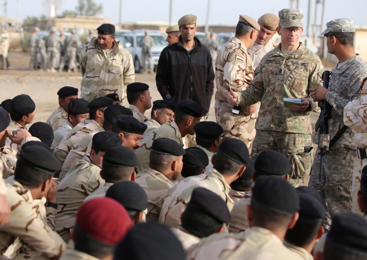 Command Sergeant Major Tony Grinston speaks to Iraqi soldiers at the Taji base complex, which is located north of Baghdad.