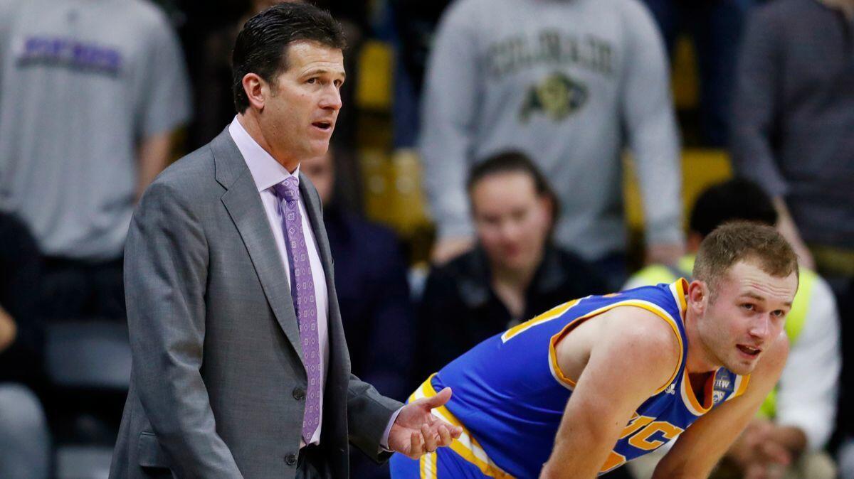 UCLA guard Bryce Alford, right, confers with UCLA Coach Steve Alford, his father, as time runs out in the team's game against Colorado on Jan. 12.