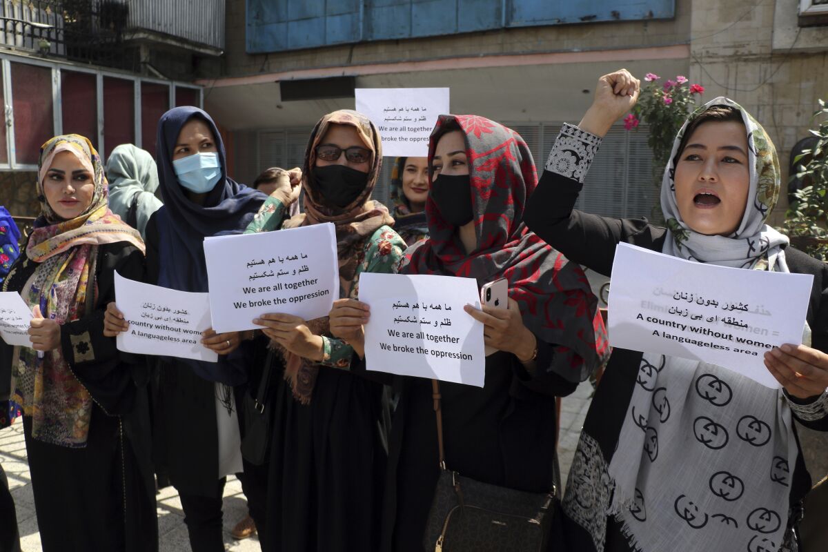 Women gather to demand their rights under the Taliban rule during a protest in Kabul