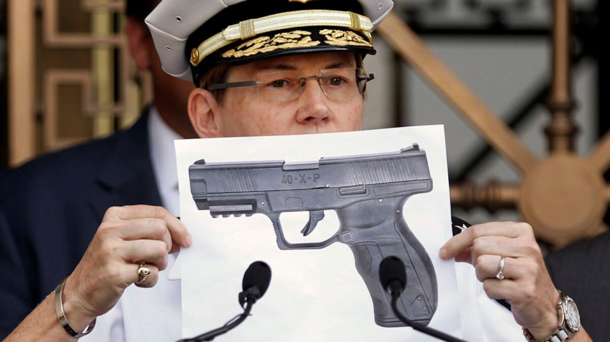 Columbus Police Chief Kim Jacobs, in September, displays a photo showing the type of BB gun that police say 13-year-old Tyre King pulled from his waistband just before he was shot and killed by a police officer investigating an armed robbery report.