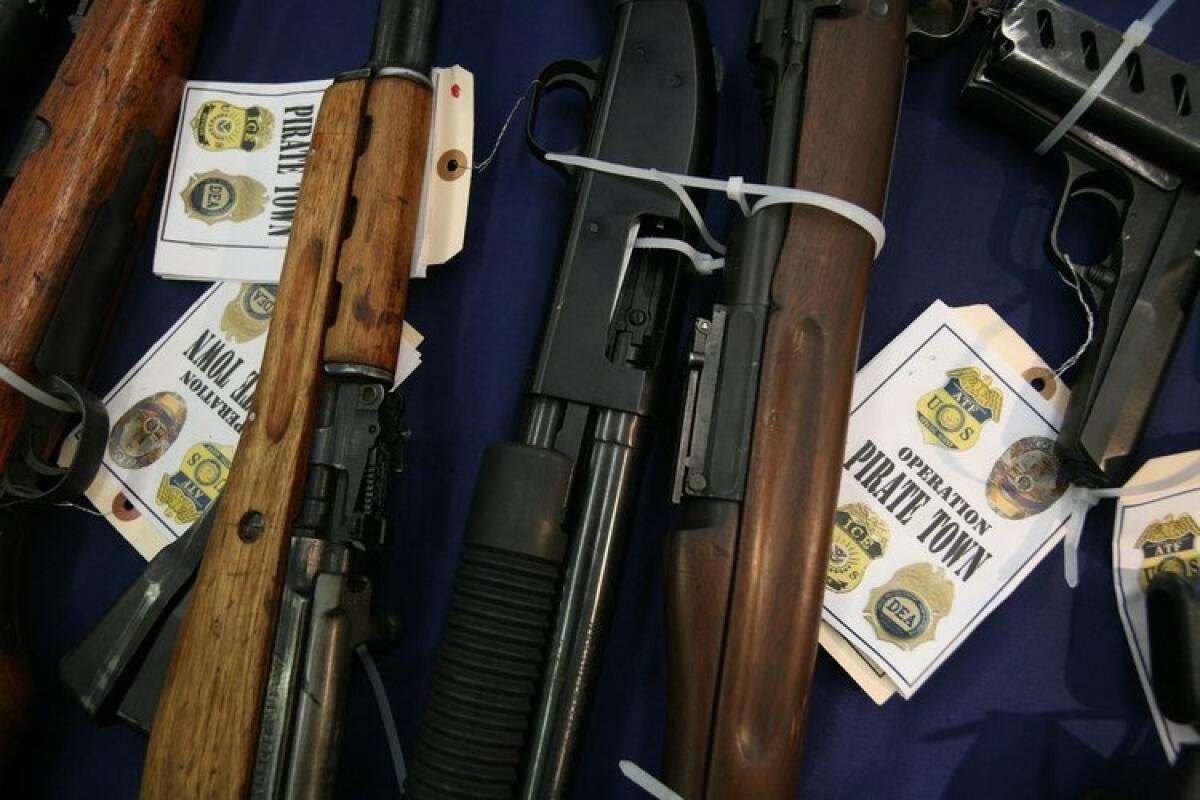 Confiscated firearms at LAPD Harbor Station after more than 1,300 federal and local law enforcement officers participated in a raid arresting more than 80 members and associates of the Rancho San Pedro street gang in April.