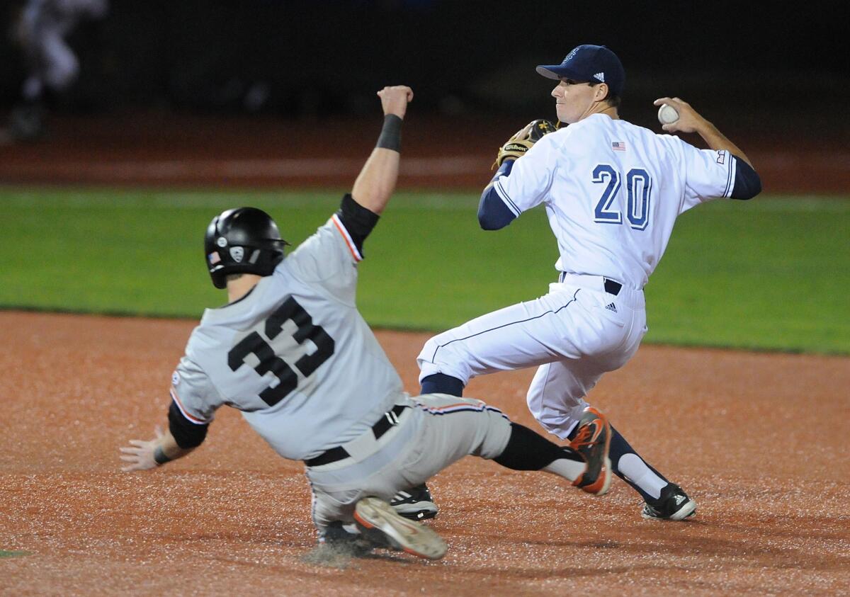 UC Irvine's John Brontsema turns a double play over Oregon State's Logan Ice to advance to the Super Regional round of the NCAA baseball tournament.