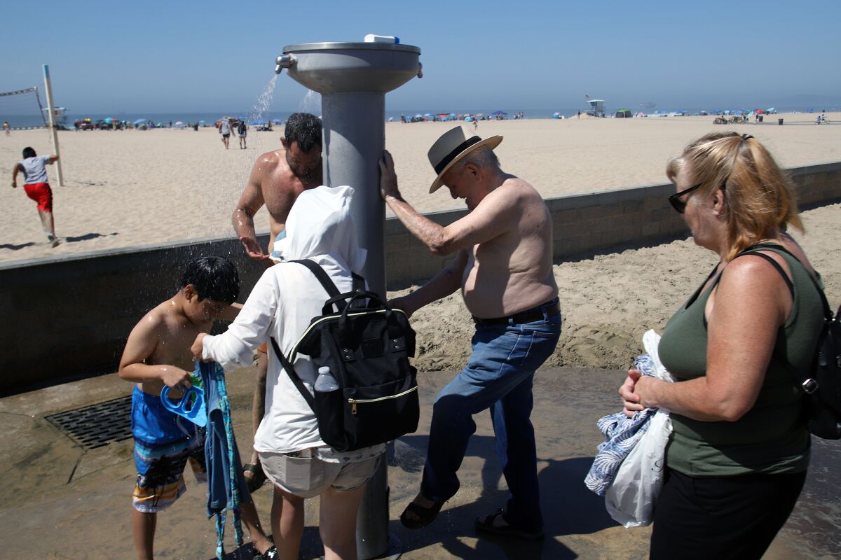 Beachgoers cool down from the hot temperatures.