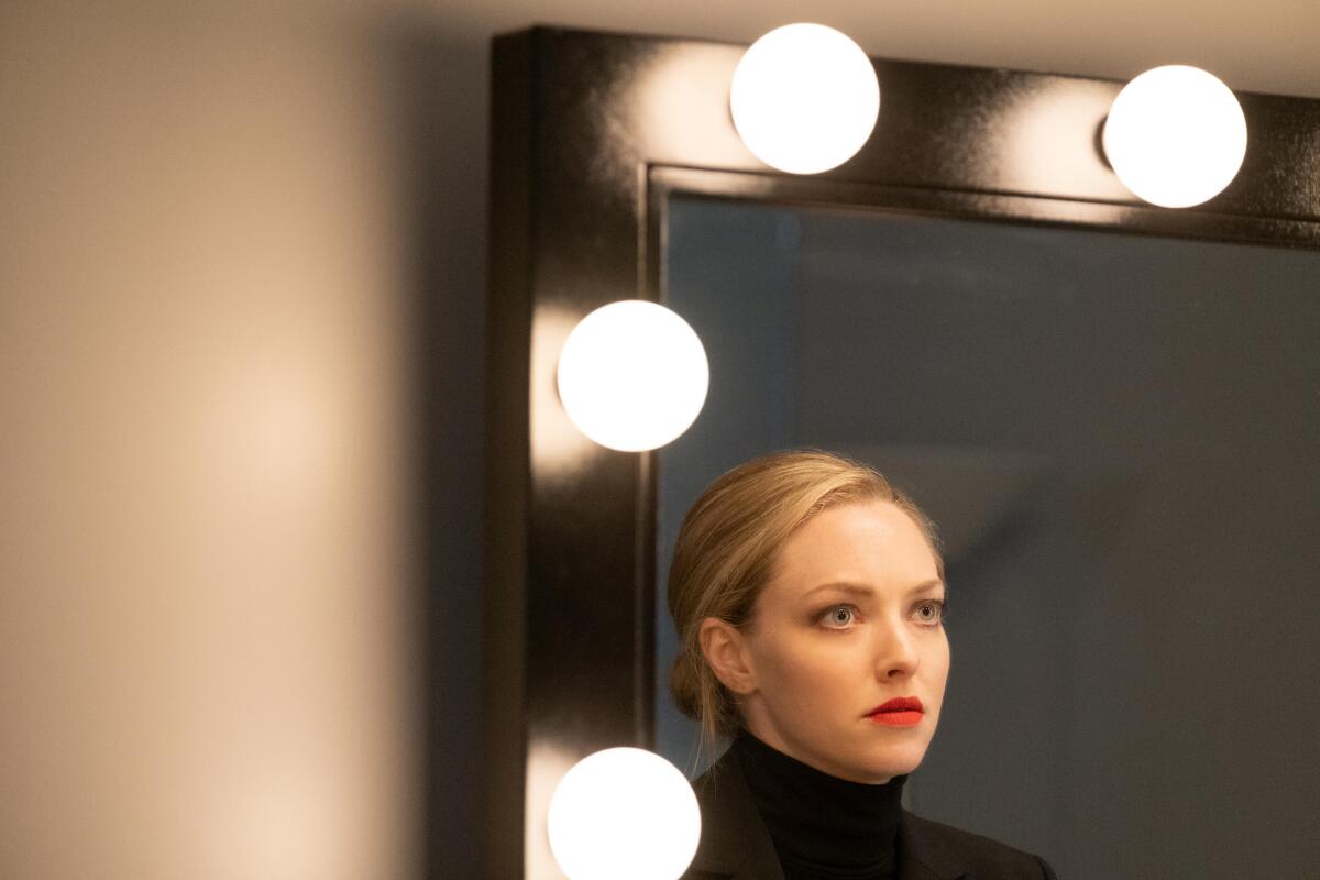 Amanda Seyfried looking at herself in a mirror