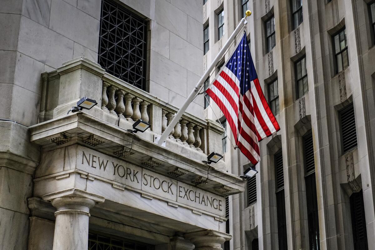 The U.S. flag flies over the side entrance to the New York Stock Exchange. 