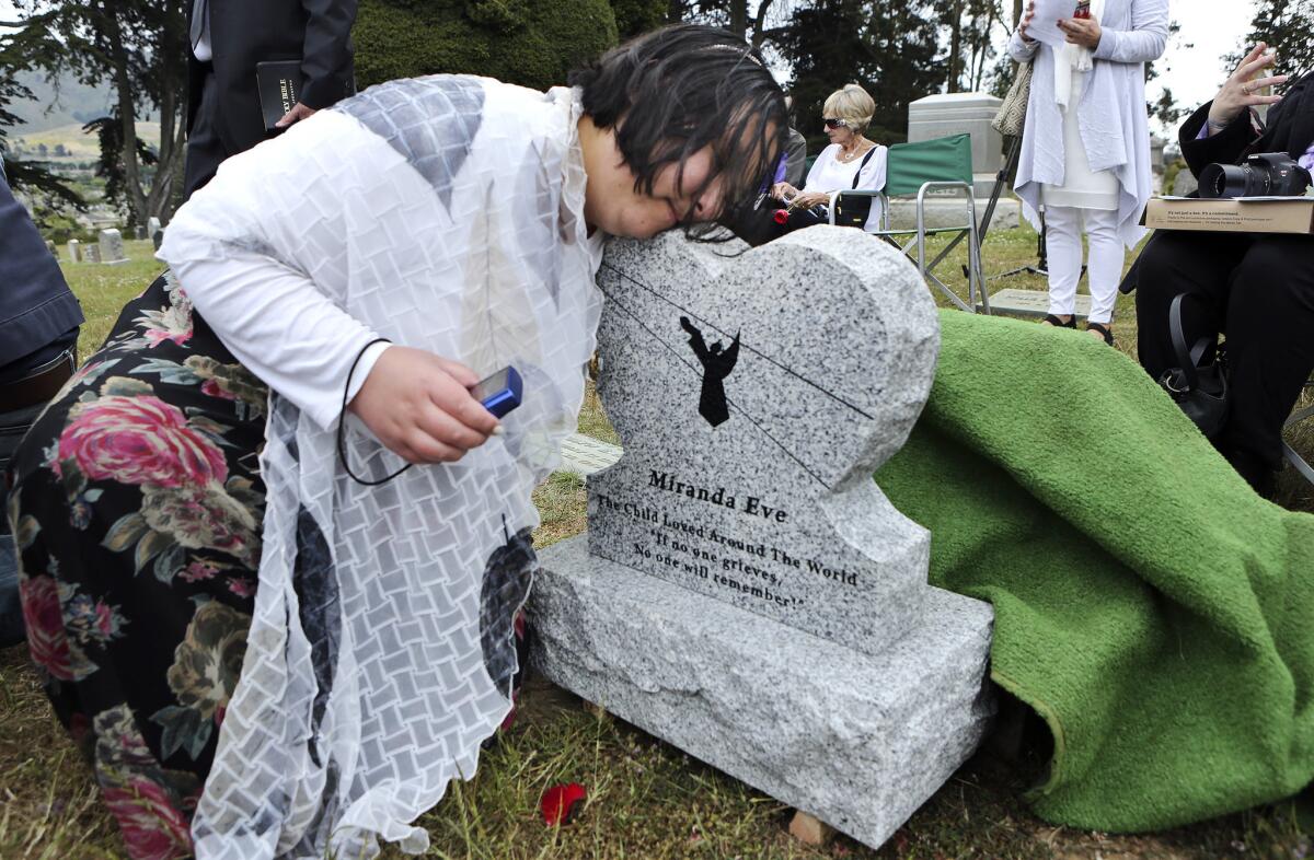 More than 100 people attended a ceremony for the girl's reburial in Colma, less than 10 miles from where she was originally buried. They christened her Miranda Eve.