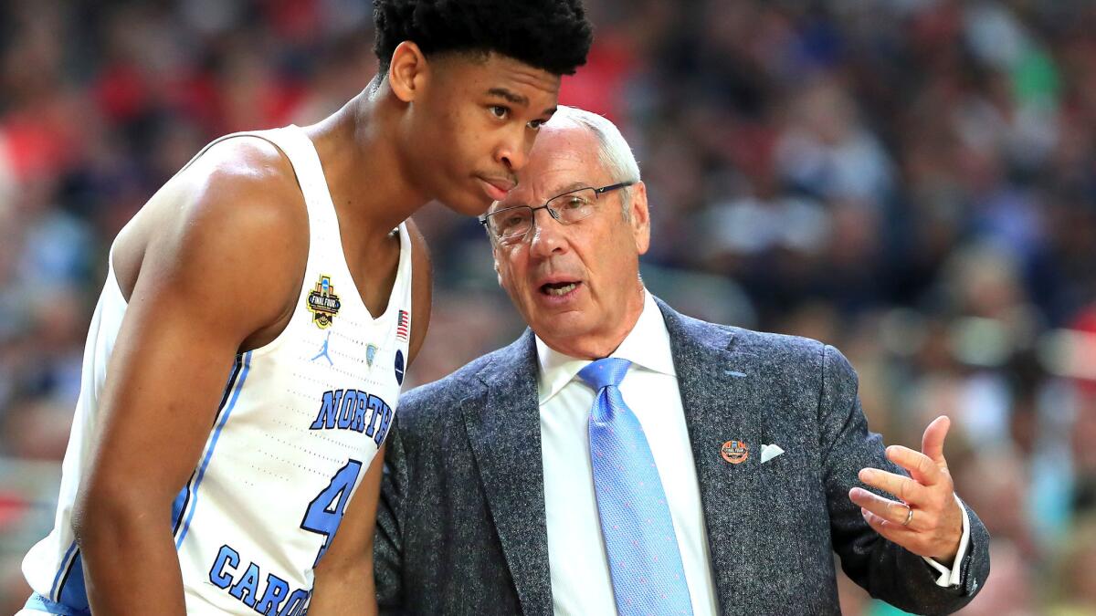 North Carolina Coach Roy Williams speaks to Isaiah Hicks during their Final Four game against Oregon on April 1.