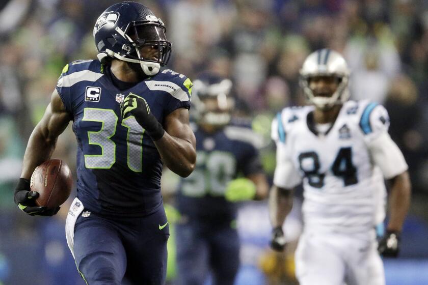 Seattle safety Kam Chancellor runs for a touchdown after an interception against Carolina in January.