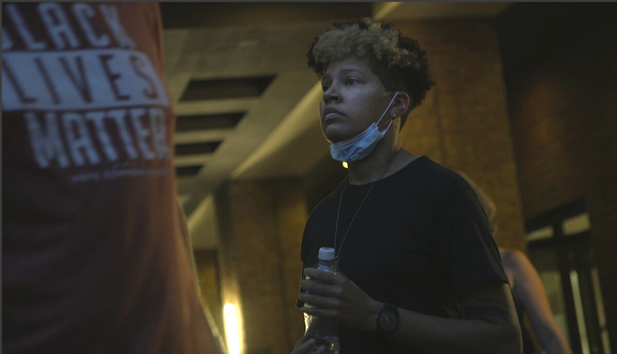 In this image taken from video, activist and rapper Genesis Be leaves her hotel on Thursday, Aug. 27, 2020, in Washington, before attending an event for Vote Common Good, a campaign aimed at Christian voters in swing states. Genesis Be helped ignite a nationwide conversation around the Confederate emblem as part of Mississippi's state flag until the flag was retired in June. (AP Photo/Federica Narancio)