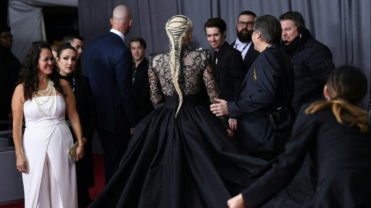 Lady Gaga, center, arrives for the 60th Grammy Awards on Sunday in New York with a Victorian-inspired hairstyle.