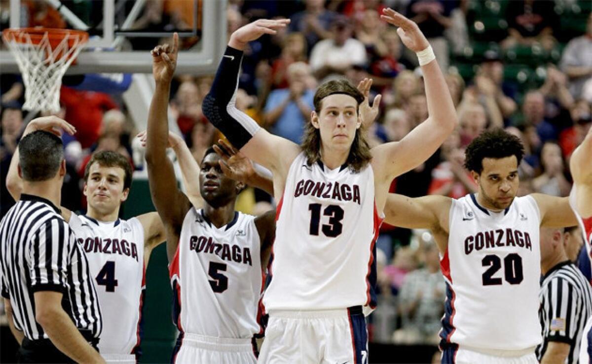 Gonzaga players celebrate as they come off the court near the end of their victory over Saint Mary's during the West Coast Conference tournament championship.