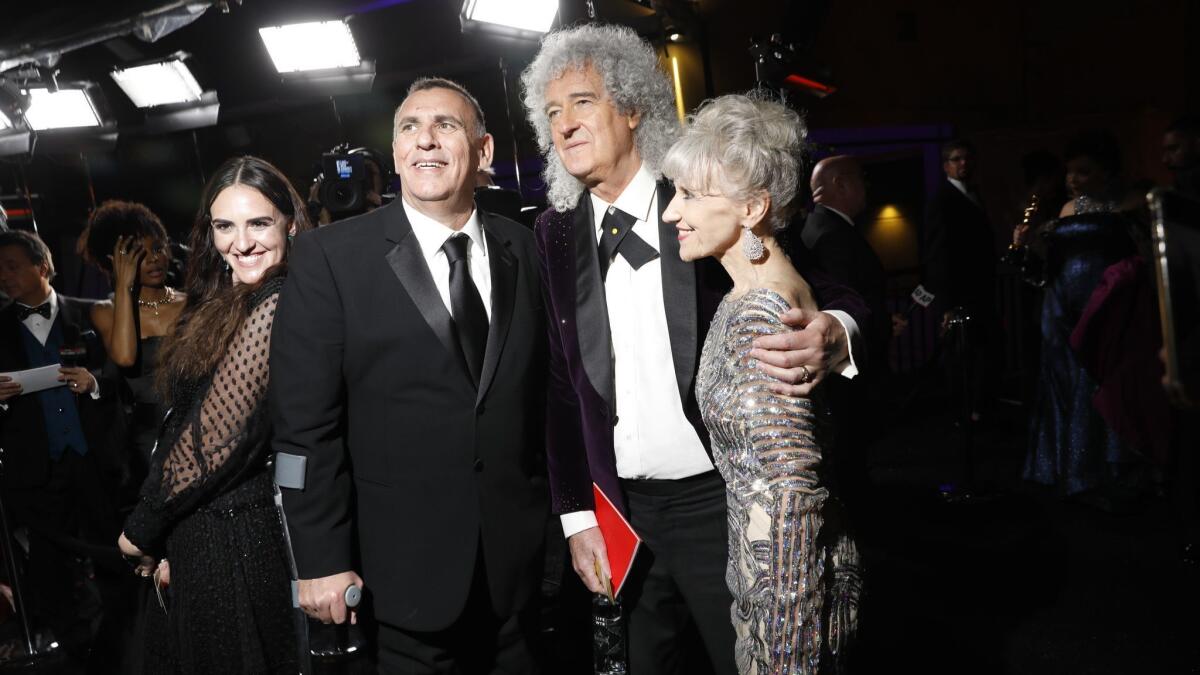 Queen guitarist Brian May, center, with his actress-wife, Anita Dobson, and "Bohemian Rhapsody" producer Graham King