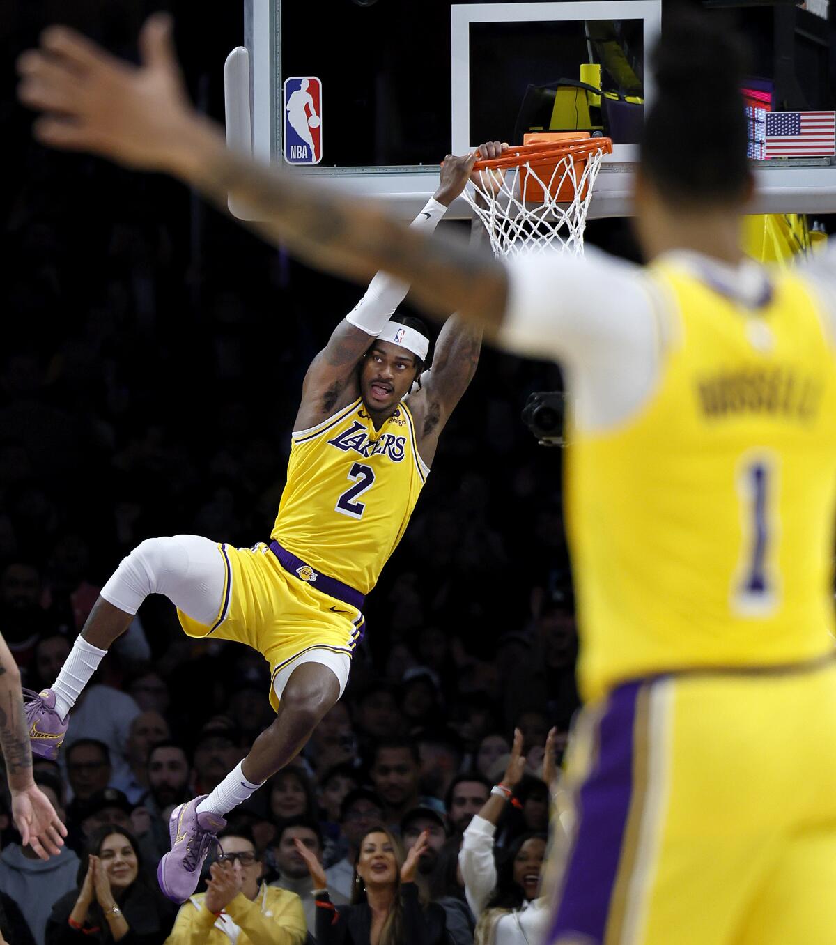 Lakers point guard D'Angelo Russell celebrates as forward Jarred Vanderbilt dunks.