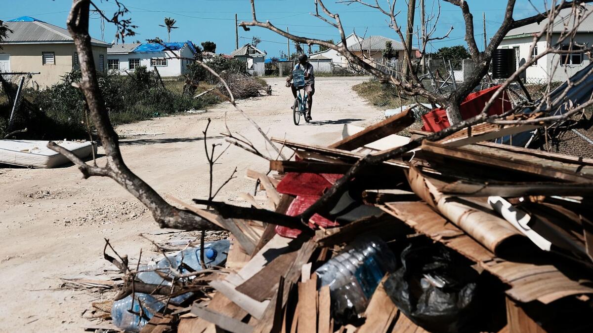Debris from damaged homes lines a street in Codrington, on the hurricane-ravaged island of Barbuda, on Dec. 8.