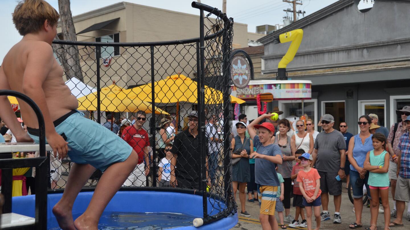 Guests line up for the dunk tank at the Balboa Island Carnival & Taste of the Island on Marine Avenue.