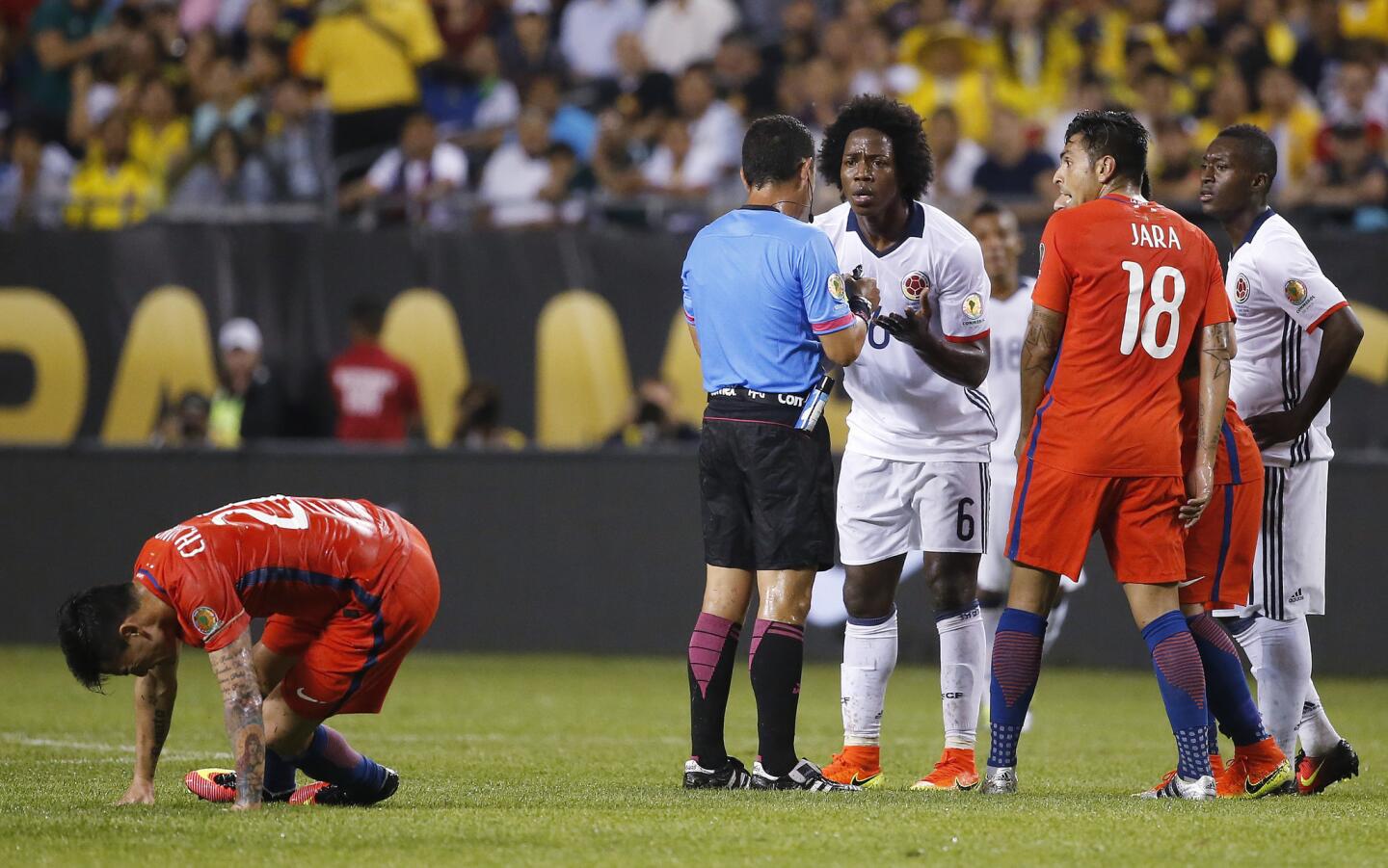 Colombia's Carlos Sanchez (6) appeals to referee Joel Aguilar after receiving the first of two yellow cards during a Copa America Centenario semifinal soccer match against Chile at Soldier Field in Chicago, Wednesday, June 22, 2016. (AP Photo/Charles Rex Arbogast)