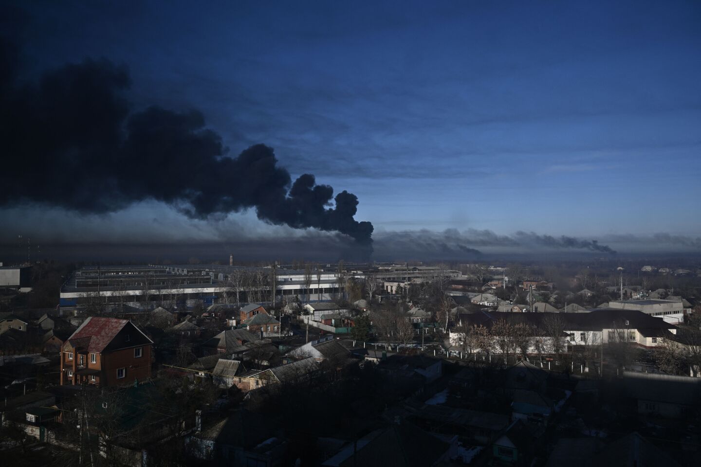 TOPSHOT - Black smoke rises from a military airport in Chuguyev near Kharkiv on February 24, 2022. - Russian President Vladimir Putin announced a military operation in Ukraine today with explosions heard soon after across the country and its foreign minister warning a "full-scale invasion" was underway. (Photo by Aris Messinis / AFP) (Photo by ARIS MESSINIS/AFP via Getty Images)