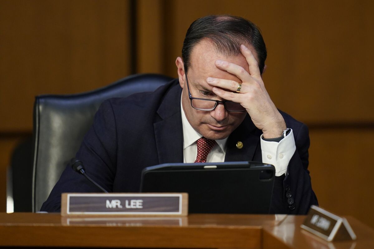 Sen. Mike Lee, R-Utah, looks to a tablet during Supreme Court nominee Judge Ketanji Brown Jackson's confirmation hearing before the Senate Judiciary Committee Tuesday, March 22, 2022, on Capitol Hill in Washington. (AP Photo/Carolyn Kaster)