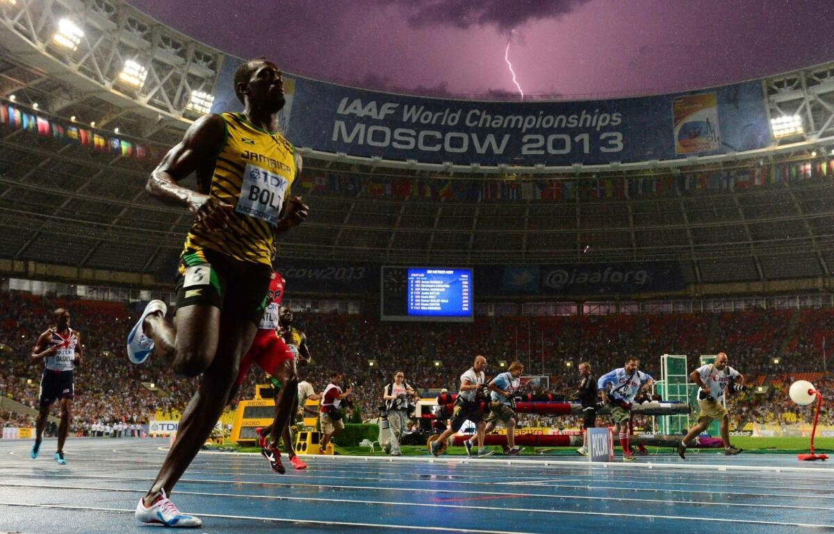 A bolt of lightning strikes just after Jamaican sprinter Usain Bolt wins the 100-meter title at the IAAF world championships in Moscow.
